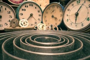 Vintage clocks and mechanical gears representing the urgency of family law limitation periods in Ontario.